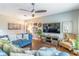 Open living room with TV, wood floors, and comfortable seating at 2031 Gloria Oak Ct, Orlando, FL 32820