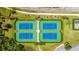 Aerial view of well-maintained tennis courts surrounded by lush landscaping at 2031 Gloria Oak Ct, Orlando, FL 32820
