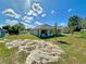 Spacious backyard featuring a lush lawn and patio area, perfect for outdoor activities at 2033 E Gloria Dr, Deltona, FL 32725