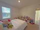 Bedroom with a large window, toys and a cozy bed at 2033 E Gloria Dr, Deltona, FL 32725