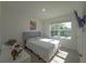 Cozy bedroom with a gray tufted headboard, bright window and contemporary decor at 2033 E Gloria Dr, Deltona, FL 32725