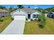 Charming single-Gathering home with a well-manicured lawn, a two-car garage, and delightful landscaping at 2033 E Gloria Dr, Deltona, FL 32725