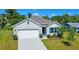 Charming single-Gathering home with a manicured lawn, vibrant landscaping, and a two-car garage at 2033 E Gloria Dr, Deltona, FL 32725