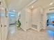 Bright and airy hallway with tile flooring, showcasing access to various rooms and entry at 2033 E Gloria Dr, Deltona, FL 32725