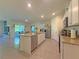 Open-concept kitchen featuring a granite island, stainless appliances, and tile flooring at 2033 E Gloria Dr, Deltona, FL 32725