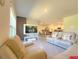 Open-concept living room flows seamlessly into the kitchen and dining area, creating a comfortable living space at 2033 E Gloria Dr, Deltona, FL 32725