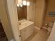 Bathroom featuring a white vanity with ample storage and decorative lighting, with neutral wall paint at 2414 Willow Oak Dr, Edgewater, FL 32141