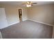 Neutral bedroom with carpet floors, ceiling fan, and views to an attached bathroom at 2414 Willow Oak Dr, Edgewater, FL 32141