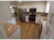 Bright kitchen showcasing stainless steel appliances, granite counters, and white cabinetry at 2414 Willow Oak Dr, Edgewater, FL 32141