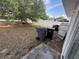 Spacious backyard view with tree, fence and containers at 266 Vervain Ave, Davenport, FL 33837
