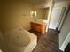 Bathroom featuring a large soaking tub, double sink vanity, and a walk-in closet at 266 Vervain Ave, Davenport, FL 33837