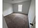 Bedroom with neutral carpeting, paint, and a window letting in plenty of natural light at 266 Vervain Ave, Davenport, FL 33837