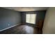 Bedroom featuring wood-look floors and a double-hung window at 266 Vervain Ave, Davenport, FL 33837