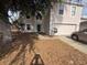 Two-story home featuring a front-facing two car garage, a lawn covered with leaves and a partial driveway at 266 Vervain Ave, Davenport, FL 33837