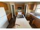 This kitchen has wood cabinets, a kitchen island with a sink, a white refrigerator, and a pantry at 266 Vervain Ave, Davenport, FL 33837