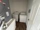Laundry room featuring a washing machine, dryer, and tiled floor at 266 Vervain Ave, Davenport, FL 33837