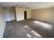 Living room featuring neutral carpeting, paint, and an arched doorway leading to another room at 266 Vervain Ave, Davenport, FL 33837