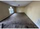 This living room is carpeted and has one window that provides natural light and a view at 266 Vervain Ave, Davenport, FL 33837