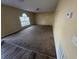 This living room is carpeted and has one window that provides natural light and a view at 266 Vervain Ave, Davenport, FL 33837