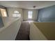 The loft features carpet flooring and windows that provide natural light at 266 Vervain Ave, Davenport, FL 33837