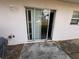 The patio features a sliding glass door and a concrete area at 266 Vervain Ave, Davenport, FL 33837