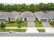 An aerial view of a gray home, featuring well-manicured landscaping and a brick-paved driveway at 2698 River Creek Ln, St Cloud, FL 34771