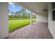 A large grassy backyard and covered patio creating an inviting outdoor space at 2698 River Creek Ln, St Cloud, FL 34771