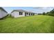 Expansive backyard featuring lush green lawn and a covered patio, perfect for outdoor enjoyment at 2698 River Creek Ln, St Cloud, FL 34771