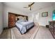 Primary bedroom boasts hardwood floors, large window, ceiling fan, and a vintage furniture set at 2698 River Creek Ln, St Cloud, FL 34771