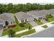 Stunning single-Gathering home featuring lush landscaping, a brick paved driveway, and a two-car garage at 2698 River Creek Ln, St Cloud, FL 34771