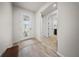 Bright foyer with light floors and a decorative glass door with sidelights and a view into the hall at 2698 River Creek Ln, St Cloud, FL 34771