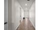 Bright hallway with white walls and floors that leads to the front of the home at 2698 River Creek Ln, St Cloud, FL 34771