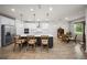Open kitchen with a large center island, white countertops, and stylish pendant lighting at 2698 River Creek Ln, St Cloud, FL 34771