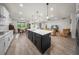 Open kitchen and living room featuring a large island, white countertops, and an open floor plan at 2698 River Creek Ln, St Cloud, FL 34771
