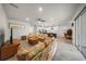 Bright, open-concept living room with ceiling fan, and an eat-in kitchen featuring an island with barstool seating at 2698 River Creek Ln, St Cloud, FL 34771