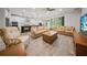 Open concept living space with an adjacent kitchen featuring tile floors and large windows at 2698 River Creek Ln, St Cloud, FL 34771