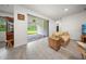 Cozy sitting area with sliding glass door that opens to a spacious covered patio and manicured lawn at 2698 River Creek Ln, St Cloud, FL 34771