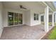 Covered patio area with sliding glass doors and ceiling fan, perfect for relaxing outdoors at 2698 River Creek Ln, St Cloud, FL 34771