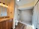 Bathroom features a modern vanity, updated walk-in shower and wood flooring at 3055 Kirkland St, Deltona, FL 32738
