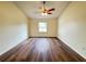 Bedroom with wood flooring, ceiling fan, a window and neutral colored walls at 3055 Kirkland St, Deltona, FL 32738