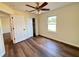 Bedroom with wood flooring, ceiling fan, closet and neutral walls at 3055 Kirkland St, Deltona, FL 32738