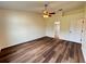 Bedroom features wood flooring, ceiling fan, and an ensuite bathroom at 3055 Kirkland St, Deltona, FL 32738