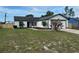 Charming single-story home with a well-maintained lawn and an attached two car garage at 3055 Kirkland St, Deltona, FL 32738