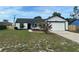 Charming single-story home with a well-maintained lawn and an attached two car garage at 3055 Kirkland St, Deltona, FL 32738