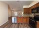 Updated kitchen with stainless steel appliances, granite countertops, and an open view of the living area at 3055 Kirkland St, Deltona, FL 32738