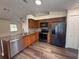 Modern kitchen featuring stainless steel appliances, granite countertops, and wooden cabinets at 3055 Kirkland St, Deltona, FL 32738