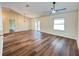 Open floor plan with hardwood floors, ceiling fan and neutral colors, providing a bright and airy space at 3055 Kirkland St, Deltona, FL 32738
