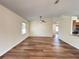 Spacious living room with hardwood floors, a ceiling fan, and plenty of natural light at 3055 Kirkland St, Deltona, FL 32738