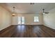Large, open living area with hardwood floors, ceiling fan, and French doors overlooking the backyard pool at 3055 Kirkland St, Deltona, FL 32738