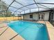 Pool and jacuzzi featuring screened enclosure and view of home at 3055 Kirkland St, Deltona, FL 32738